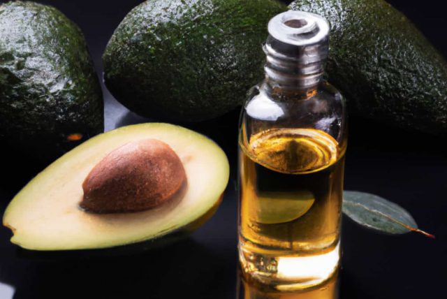 Cold pressed avocado oil in a bottle. Surrounded by fresh organic avocados