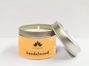 Sandalwood soy wax candle in a light orange tin